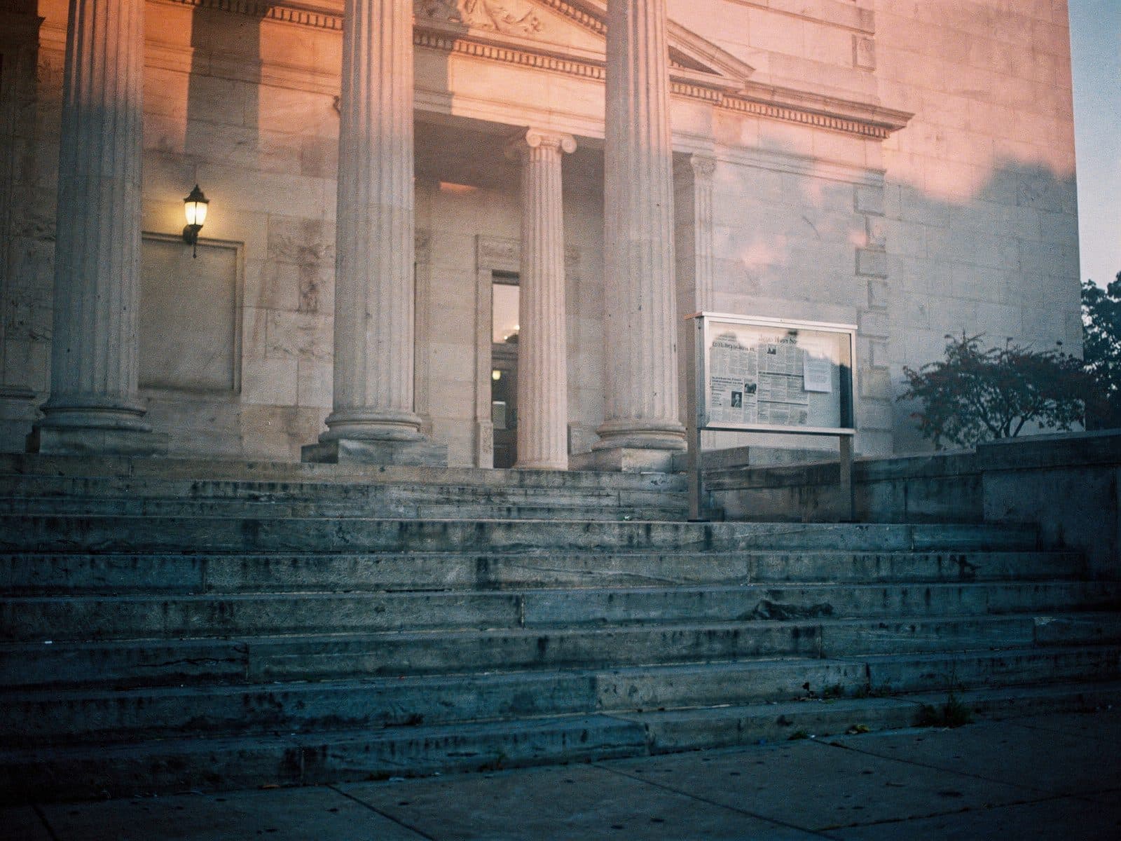 Stone steps and columns of a county courthouse at dawn